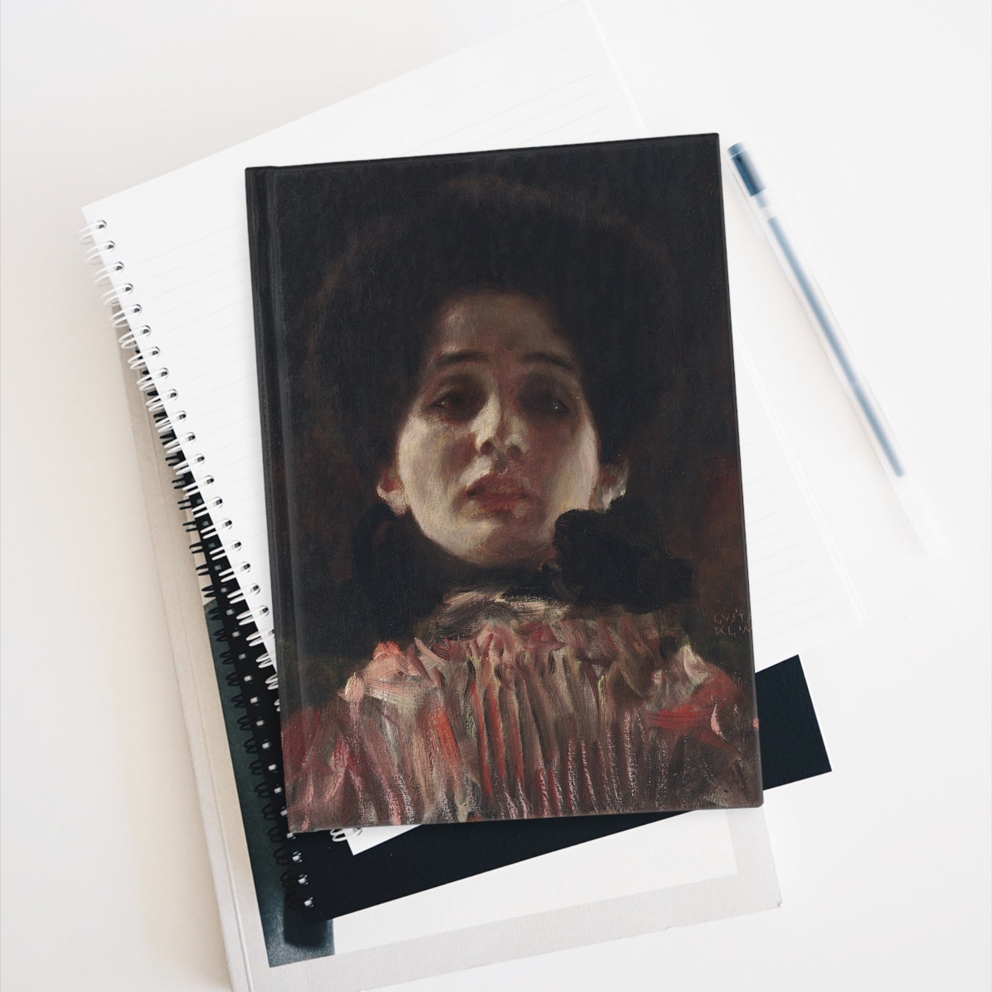 Notebook with a portrait cover on a white surface