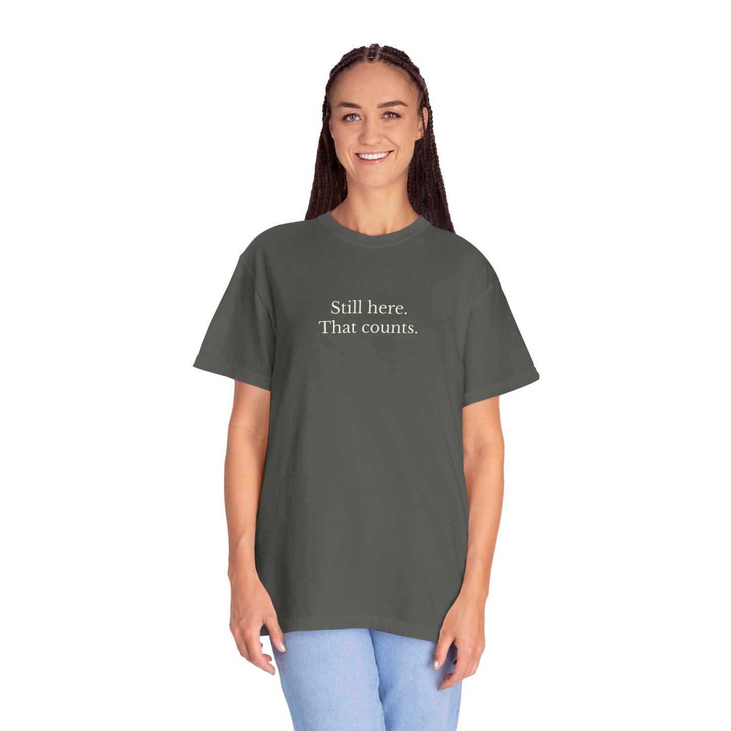 Person wearing a dark gray t-shirt with text on a white background