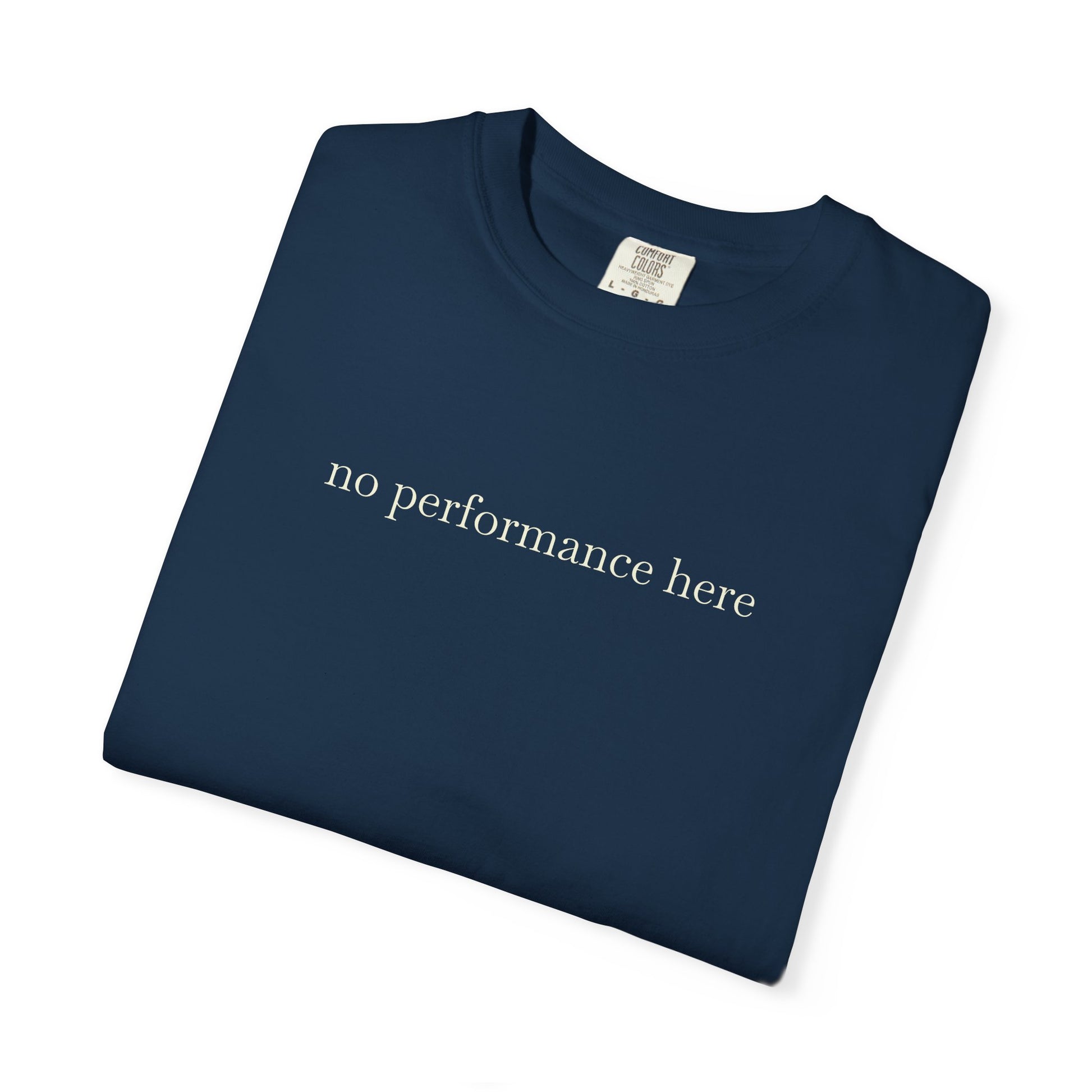 Folded navy blue t-shirt with 'no performance here' text on a white background