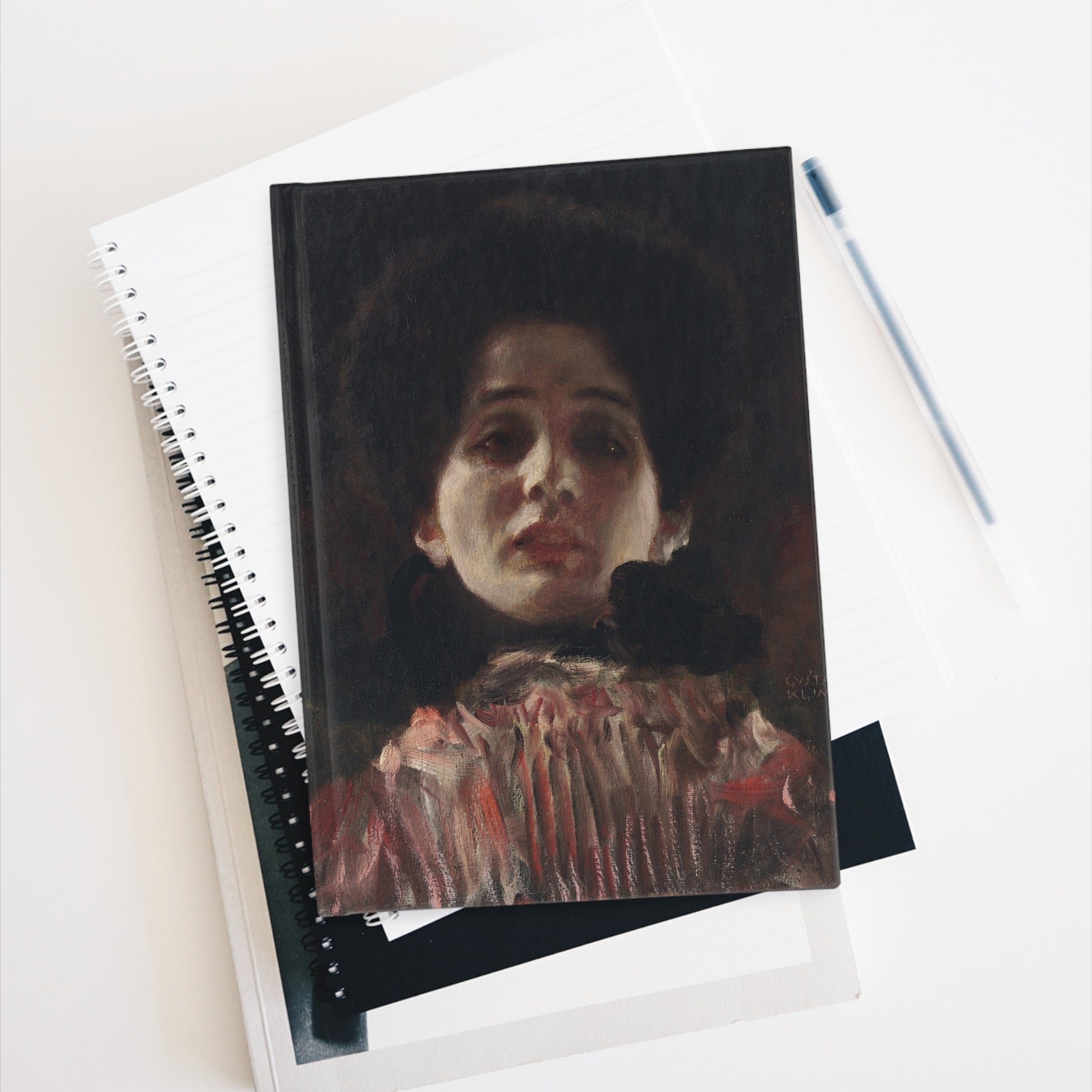 Notebook with a portrait cover on a white surface