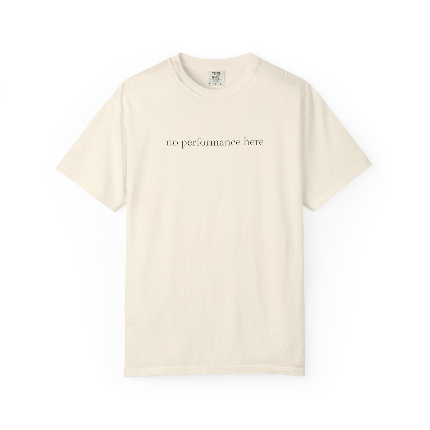 Beige t-shirt with 'no performance here' text on a white background