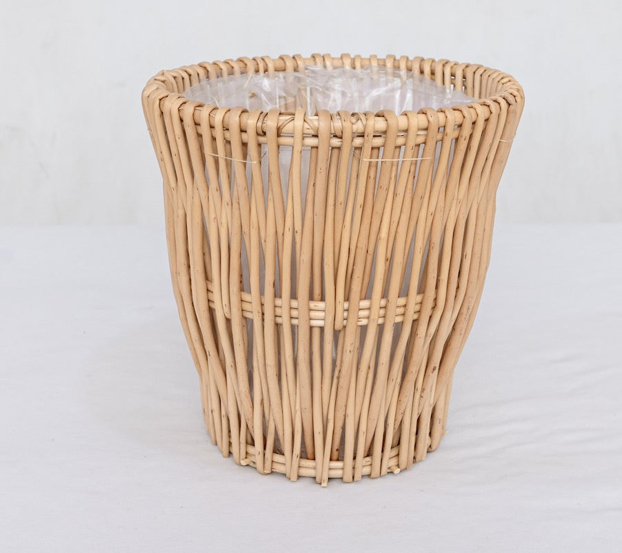 Wicker trash can on a white background