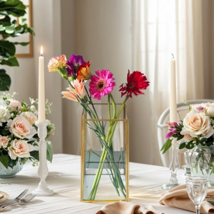 Decorative table setting with flowers, candles, and cutlery in a home setting.