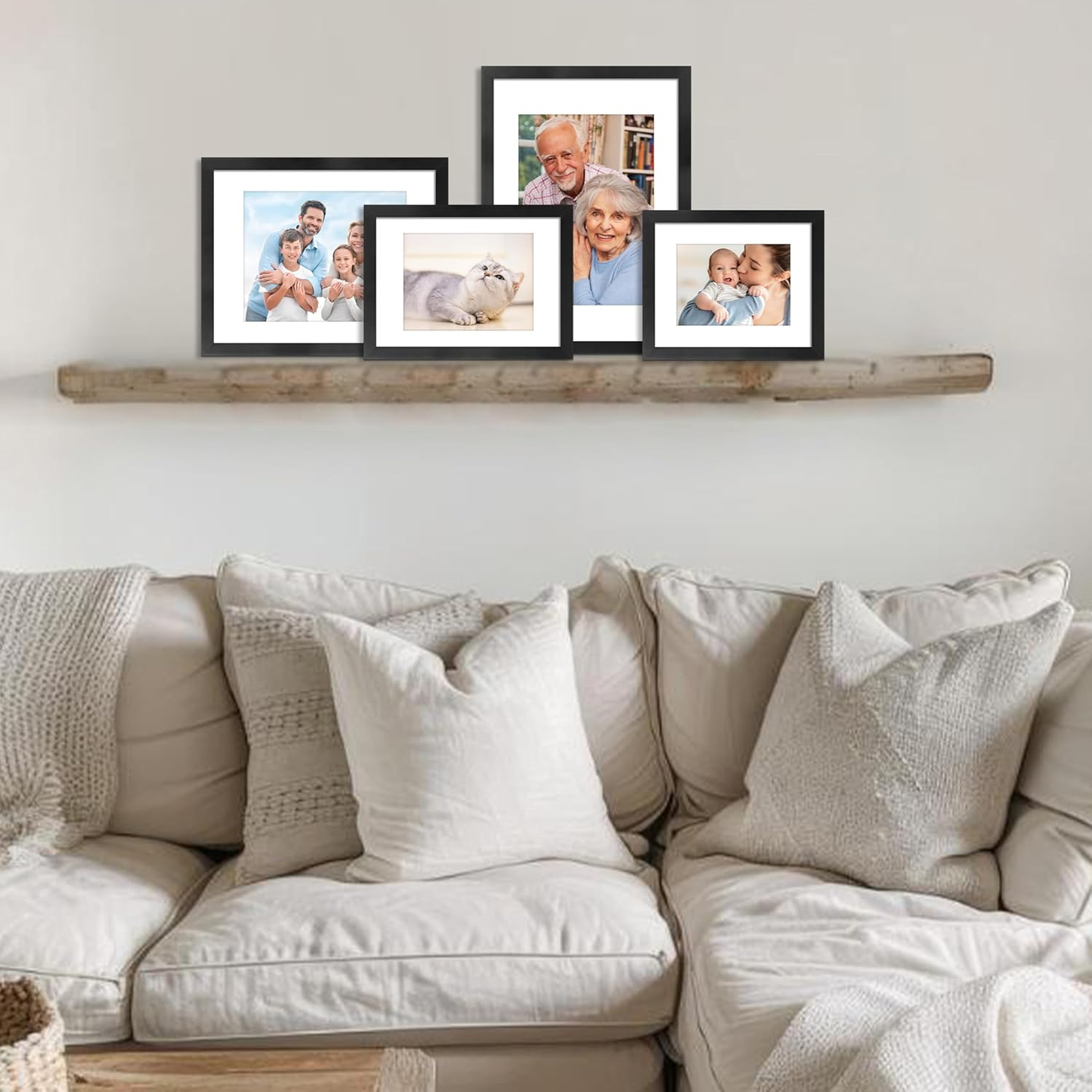 Framed family photos on a wall above a beige sofa with decorative pillows.